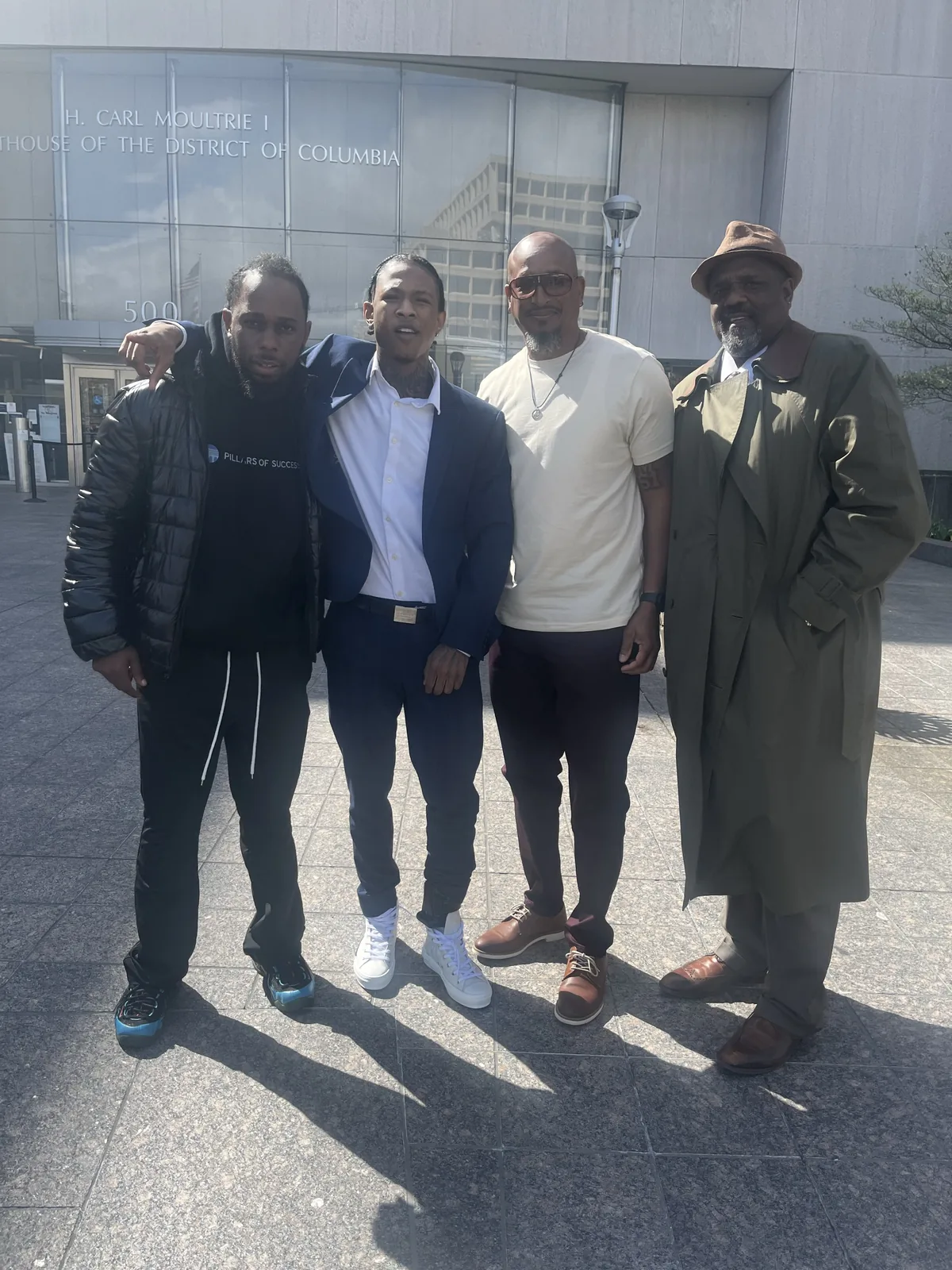 Pillars of Success representatives gathered outside a community institution